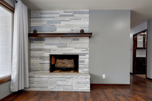 704 King St, Mount Vernon, MO 65712 - interior details featuring a fireplace, wood finished floors, and baseboards