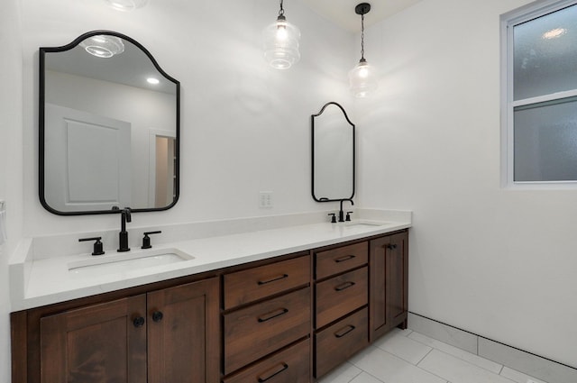 bathroom with double vanity, tile patterned floors, and a sink