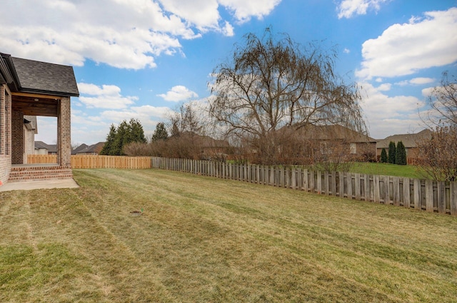 view of yard with a fenced backyard
