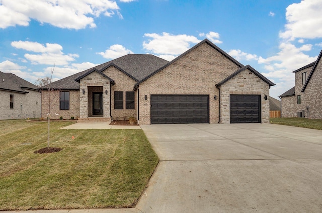 french country home with a garage, driveway, a front lawn, and brick siding