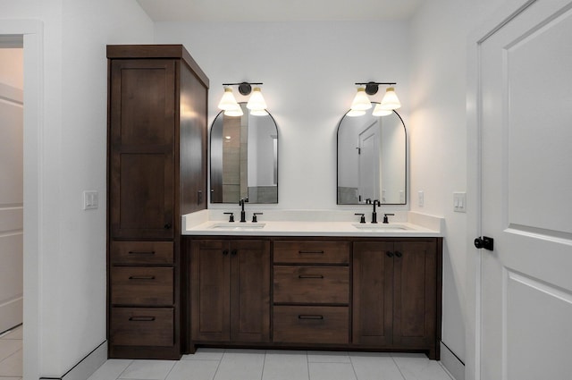 bathroom with double vanity, tile patterned floors, and a sink