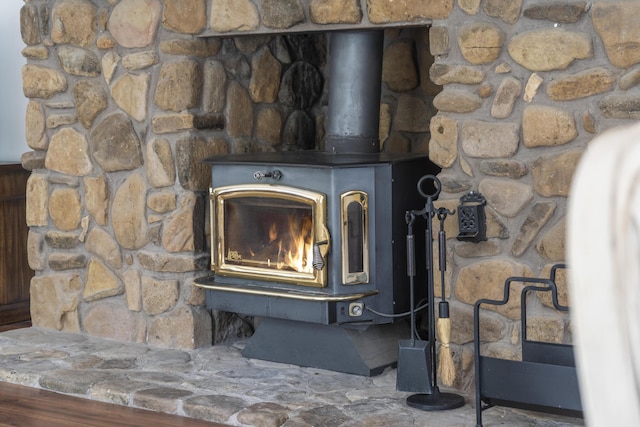 interior details with water heater and a wood stove