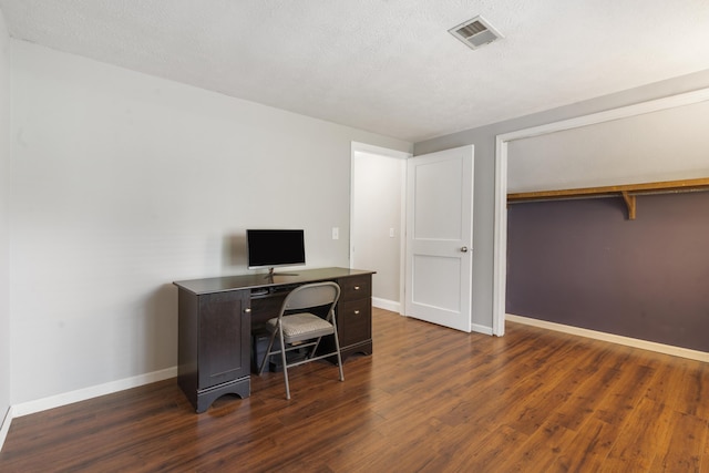 office area featuring wood finished floors, visible vents, and baseboards