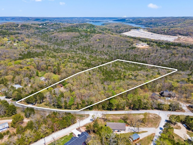 birds eye view of property featuring a wooded view