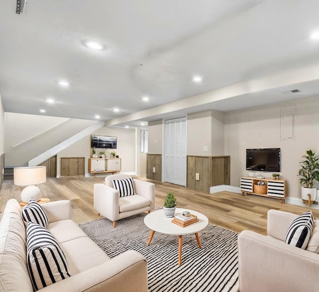 living room featuring recessed lighting, stairway, visible vents, light wood-type flooring, and baseboards
