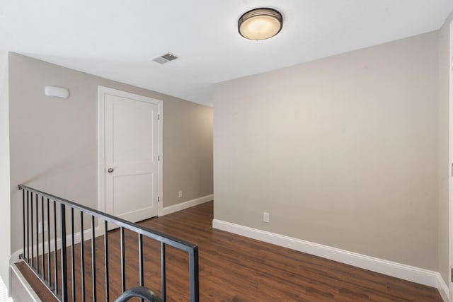 interior space with wood finished floors, visible vents, and baseboards