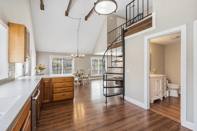 kitchen with brown cabinets, dark wood finished floors, light countertops, and high vaulted ceiling