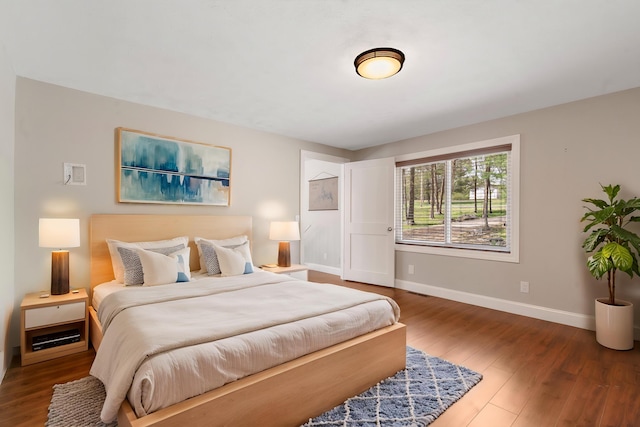 bedroom featuring baseboards and wood finished floors