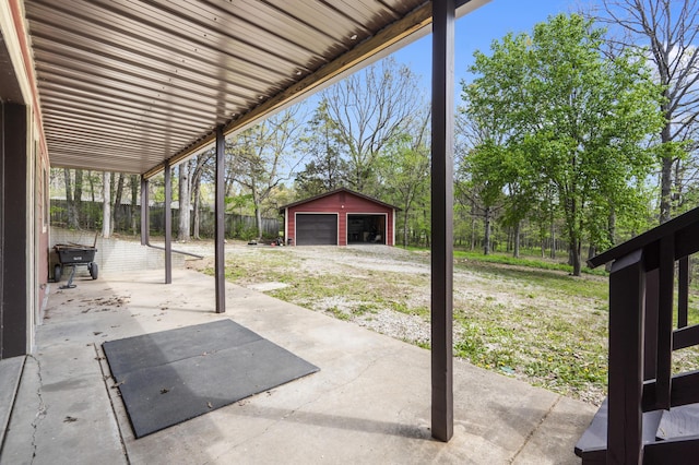 view of patio with an outdoor structure and a detached garage
