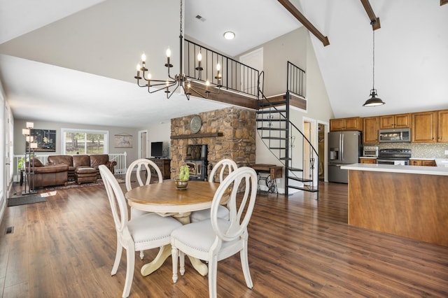 dining area with high vaulted ceiling, dark wood-style flooring, stairs, and visible vents