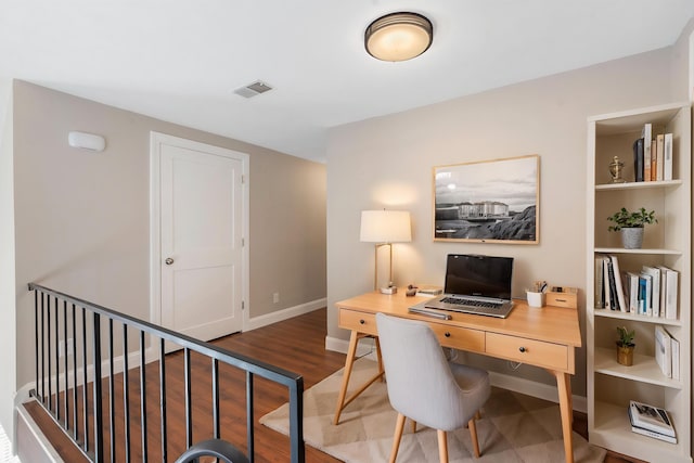 home office with baseboards, wood finished floors, and visible vents