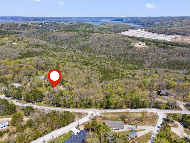 drone / aerial view featuring a forest view