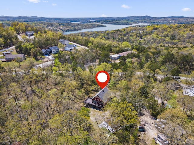 aerial view featuring a forest view and a water view
