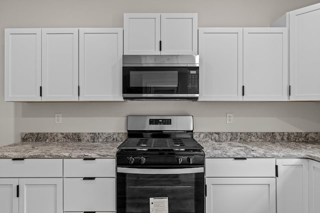 510 N Henry St, Mansfield, MO 65704 - kitchen featuring light stone countertops, stainless steel appliances, and white cabinetry