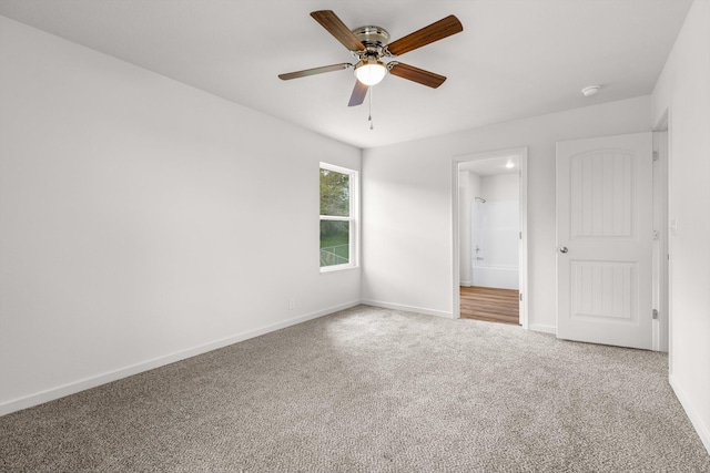 510 N Henry St, Mansfield, MO 65704 - unfurnished bedroom with ensuite bath, carpet floors, a ceiling fan, and baseboards