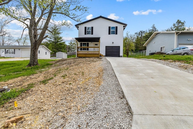 510 N Henry St, Mansfield, MO 65704 - view of front of house with an attached garage, a shed, and concrete driveway