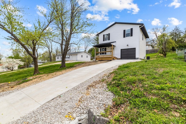 510 N Henry St, Mansfield, MO 65704 - modern farmhouse style home featuring an attached garage, a front lawn, fence, and concrete driveway