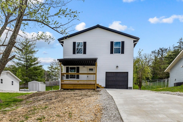 510 N Henry St, Mansfield, MO 65704 - view of front of house with a shed, concrete driveway, fence, a porch, and a garage