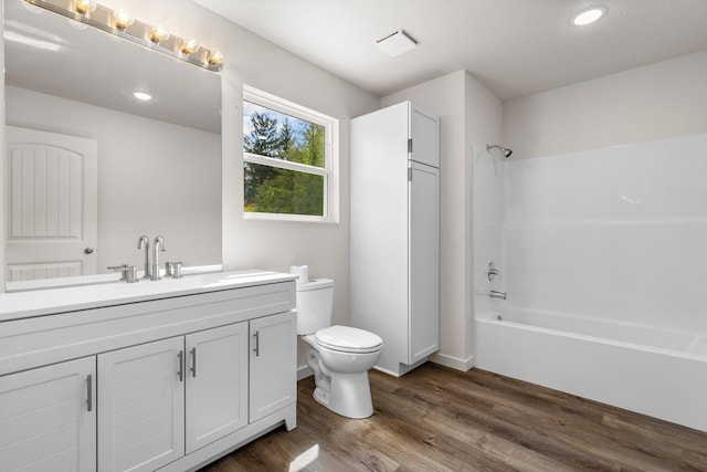 510 N Henry St, Mansfield, MO 65704 - full bath featuring wood finished floors, bathing tub / shower combination, vanity, toilet, and recessed lighting