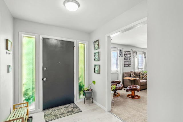 foyer entrance featuring baseboards