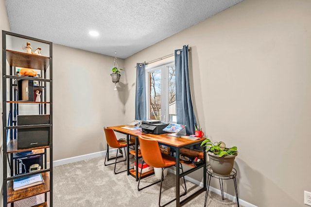 office featuring baseboards, light carpet, and a textured ceiling
