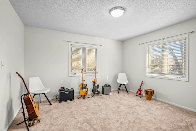 playroom with plenty of natural light, a textured ceiling, carpet floors, and baseboards