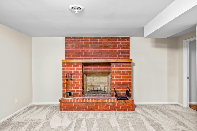 unfurnished living room featuring baseboards, a brick fireplace, carpet floors, and visible vents