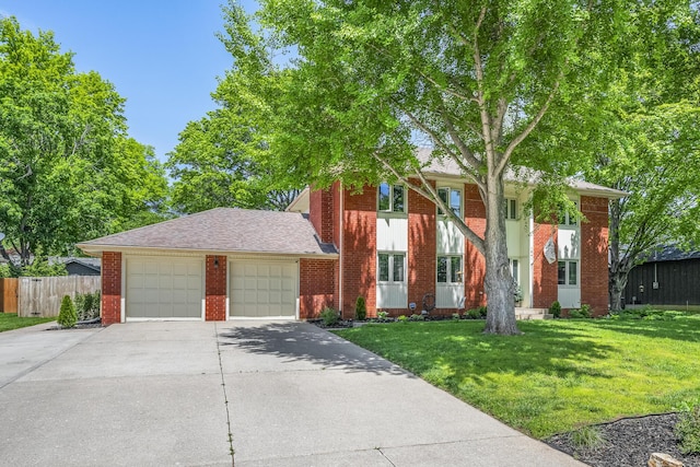 view of front of property featuring fence, a front yard, brick siding, an attached garage, and driveway