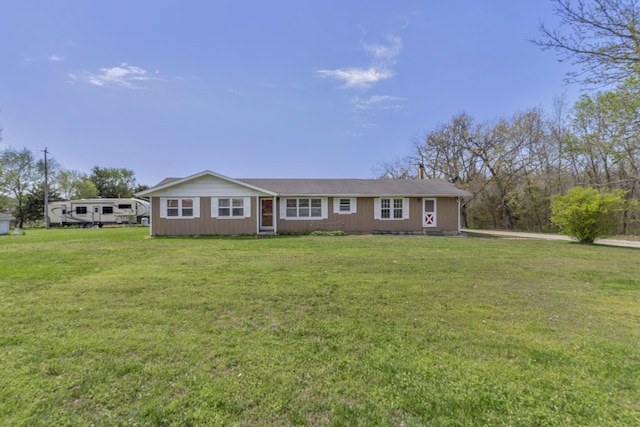 ranch-style home with a front lawn