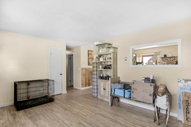 living room with baseboards and wood finished floors
