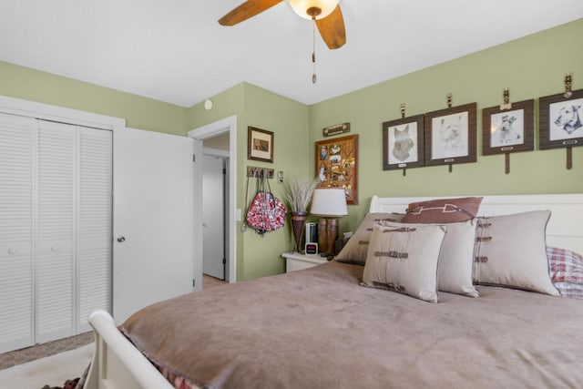 carpeted bedroom with ceiling fan and a closet