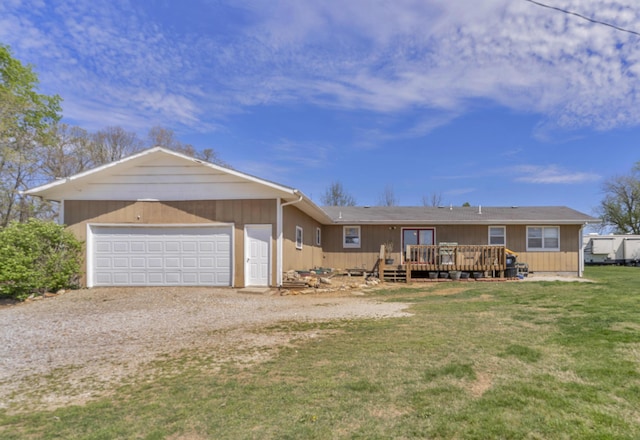 exterior space featuring a lawn, a wooden deck, dirt driveway, and a garage