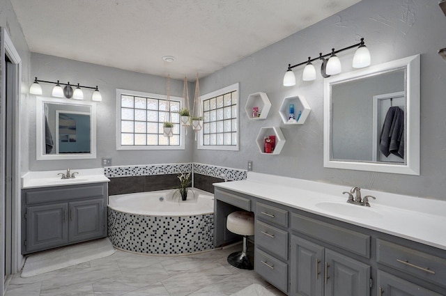 625 Parkwood Dr, Mount Vernon, MO 65712 - full bath featuring marble finish floor, a garden tub, two vanities, and a sink