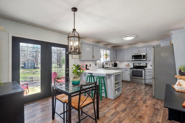 625 Parkwood Dr, Mount Vernon, MO 65712 - kitchen with a peninsula, light countertops, stainless steel appliances, and dark wood finished floors