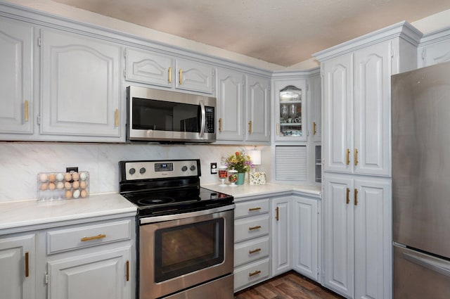 625 Parkwood Dr, Mount Vernon, MO 65712 - kitchen with light countertops, white cabinetry, appliances with stainless steel finishes, and dark wood-style flooring
