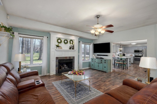 625 Parkwood Dr, Mount Vernon, MO 65712 - living area featuring dark wood finished floors, baseboards, a ceiling fan, and a tile fireplace