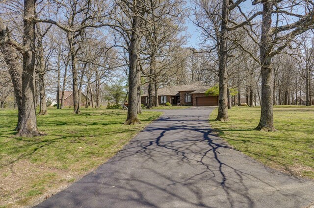 625 Parkwood Dr, Mount Vernon, MO 65712 - view of front of home featuring an attached garage, driveway, and a front yard
