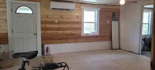 entrance foyer with wooden walls and an AC wall unit
