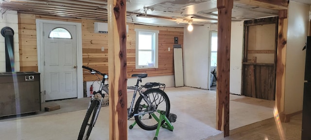 interior space featuring a healthy amount of sunlight and wood walls