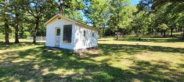 view of shed featuring fence