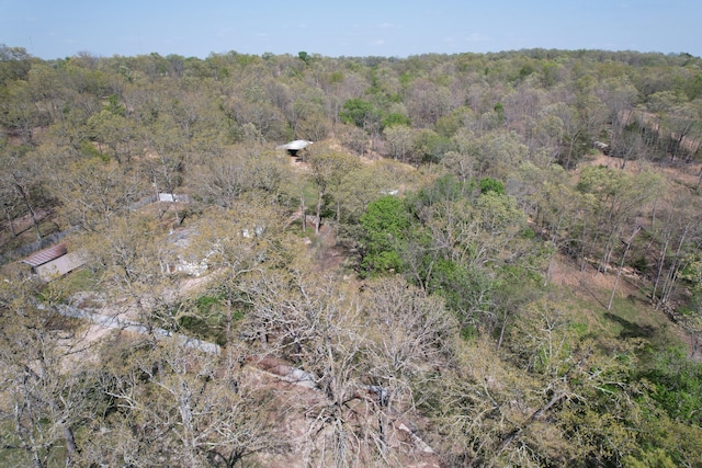 bird's eye view with a wooded view