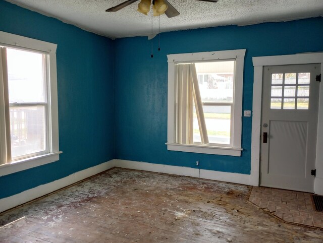 215 N Central Ave, Monett, MO 65708 - entryway with a textured ceiling, a ceiling fan, and baseboards