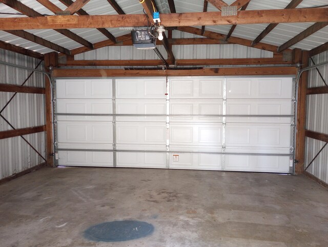215 N Central Ave, Monett, MO 65708 - garage featuring a garage door opener and metal wall