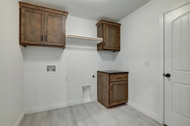 washroom with cabinet space, washer hookup, baseboards, and electric dryer hookup