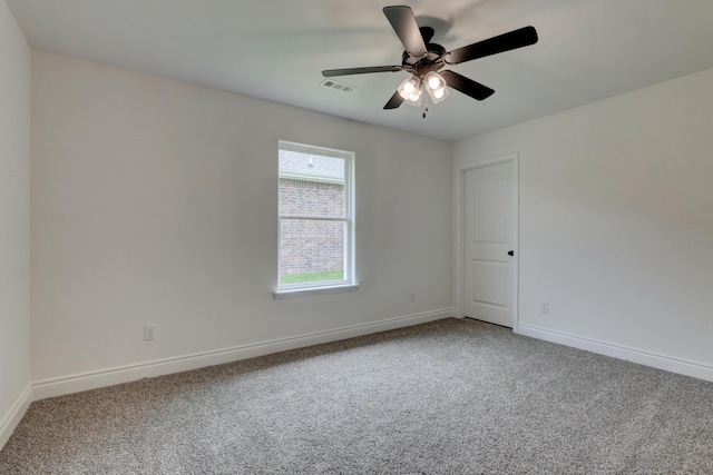 empty room with carpet flooring, baseboards, and ceiling fan