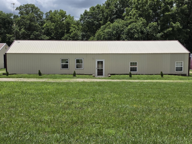 1978 E 473rd Rd, Halfway, MO 65663 - view of side of home featuring a lawn, a pole building, a metal roof, and an outbuilding