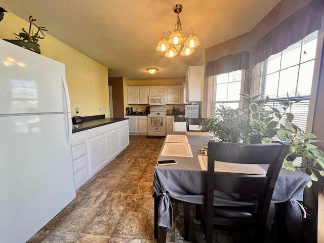 418 N Harrington Dr, Republic, MO 65738 - dining area with stone finish floor and a chandelier