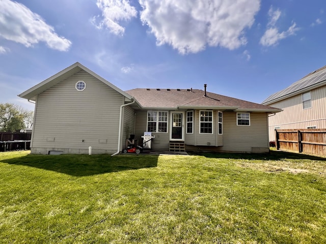 418 N Harrington Dr, Republic, MO 65738 - back of house with fence, a yard, a shingled roof, and entry steps