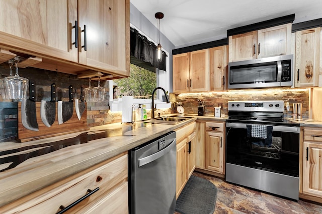 kitchen with light brown cabinets, decorative backsplash, stainless steel appliances, and a sink
