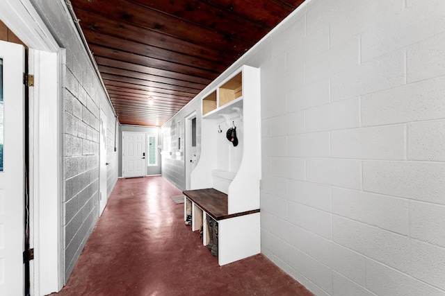 mudroom with concrete flooring and wooden ceiling
